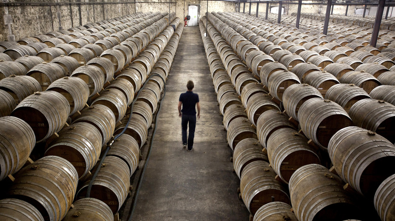 Man walking through cognac warehouse