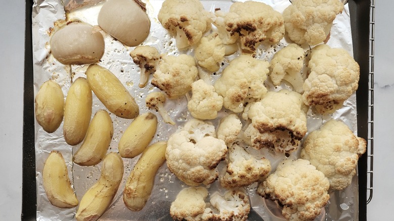 potatoes and cauliflower on a roasting pan