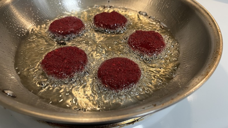 frying beet falafel in skillet