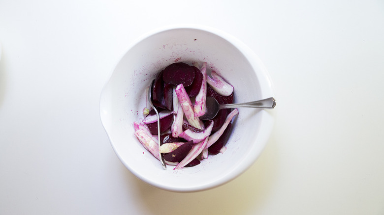 sliced vegetables in mixing bowl