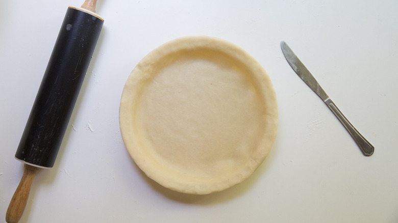 fresh dough lining pie pan