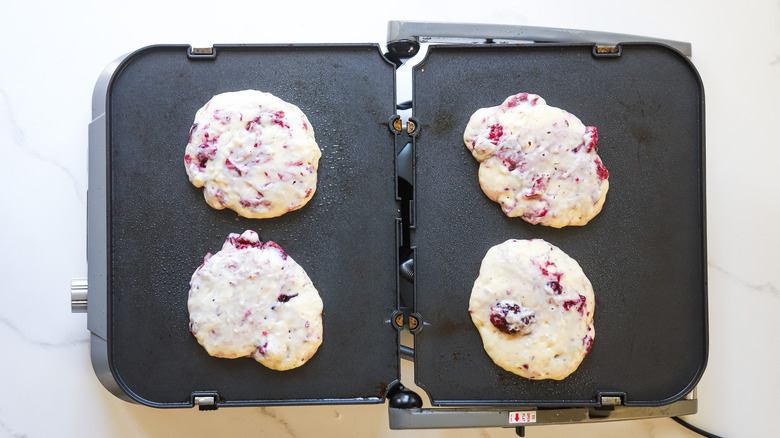 Pancakes cooking on nonstick griddle