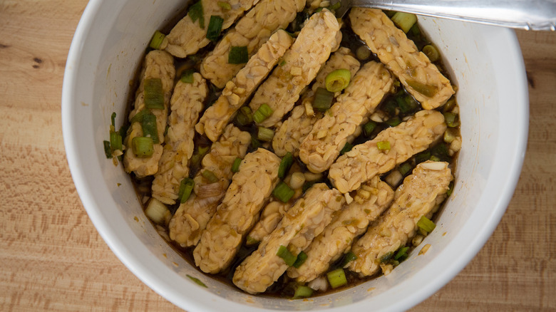 tempeh marinating in white bowl 