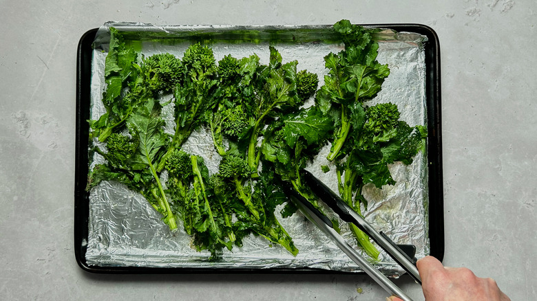 tossing broccoli rabe with oil