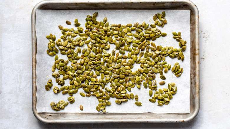 pumpkin seeds on baking sheet 