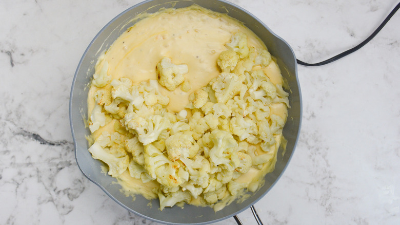 cauliflower florets added to pan