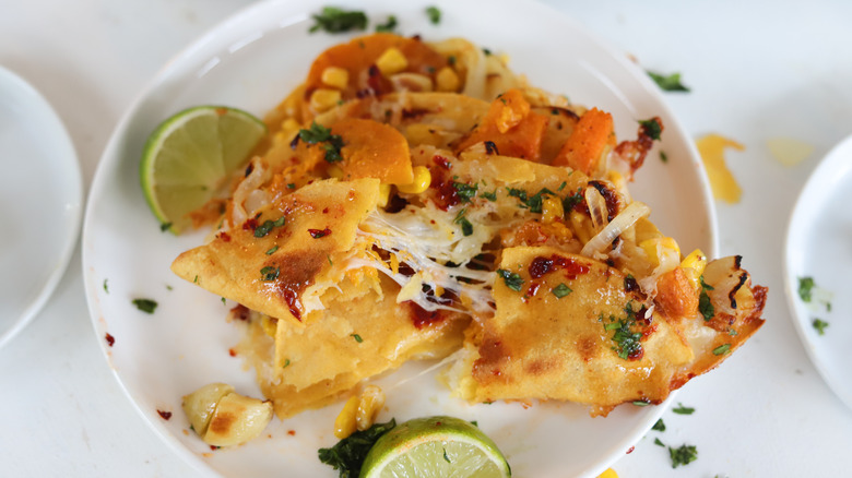 squash and corn quesadilla on plate with lime wedge