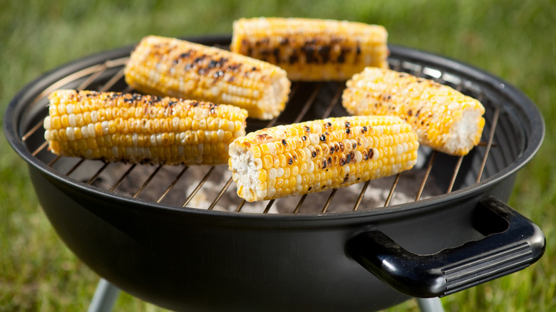 charred cobs of roasted corn on a grill