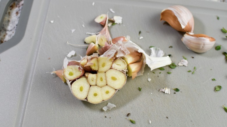 peeled garlic on cutting board