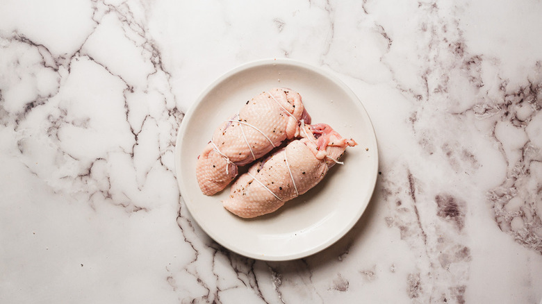 Two duck breasts tied with kitchen twine