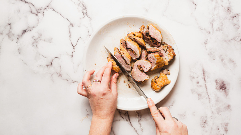 Slicing stuffed duck breasts