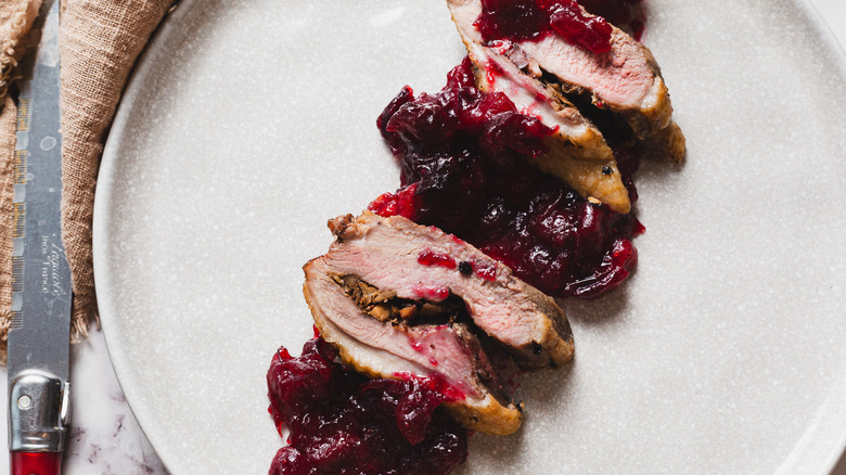 Duck breast with sauce and a knife