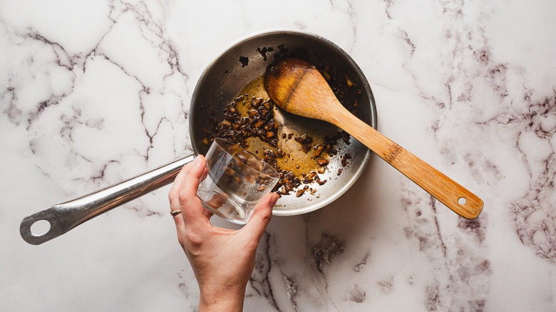 Adding wine to pan