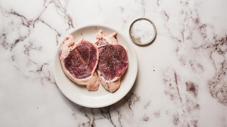 Two duck breasts with salt and pepper