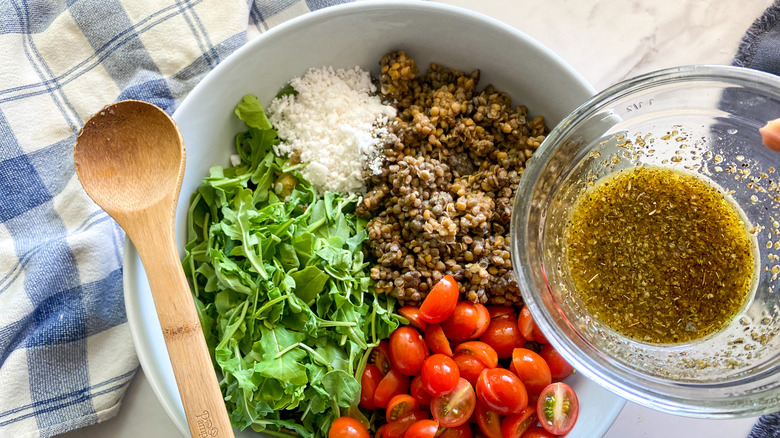 adding dressing to salad