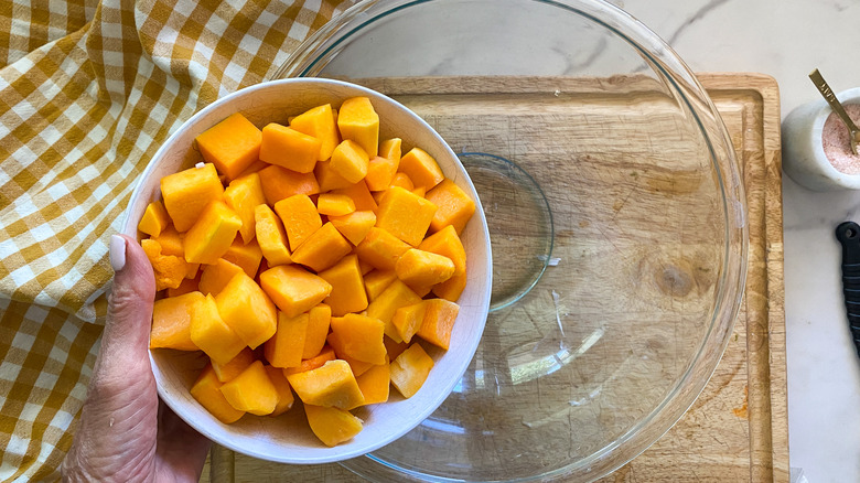 adding squash to a bowl