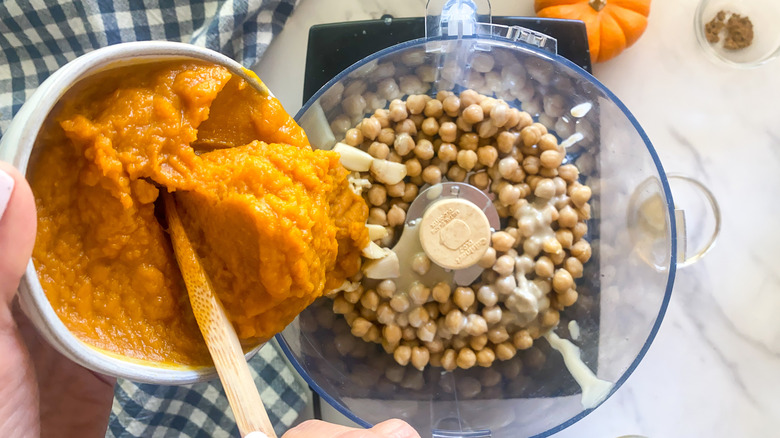 adding pumpkin to food processor