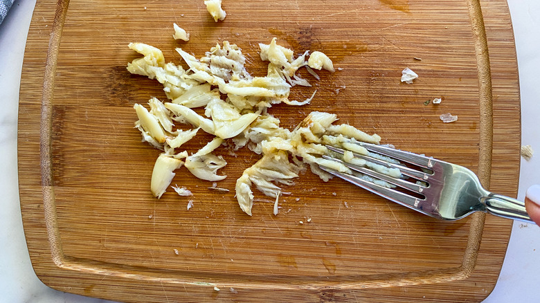 mashing garlic with fork