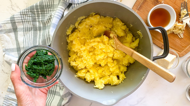 adding spinach to the pot