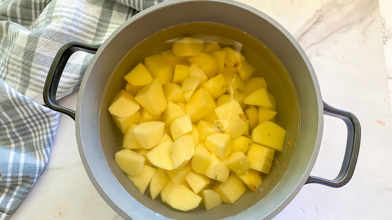 cut potatoes in pot