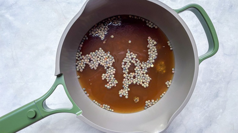 green lentils cooking in pot