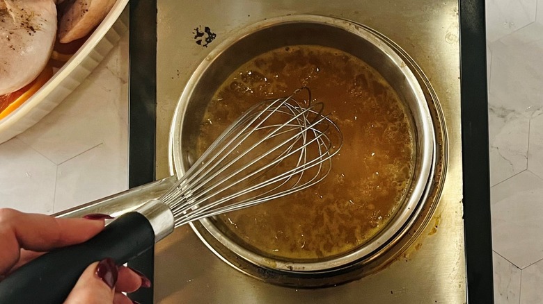 whisking marinade ingredients in saucepan