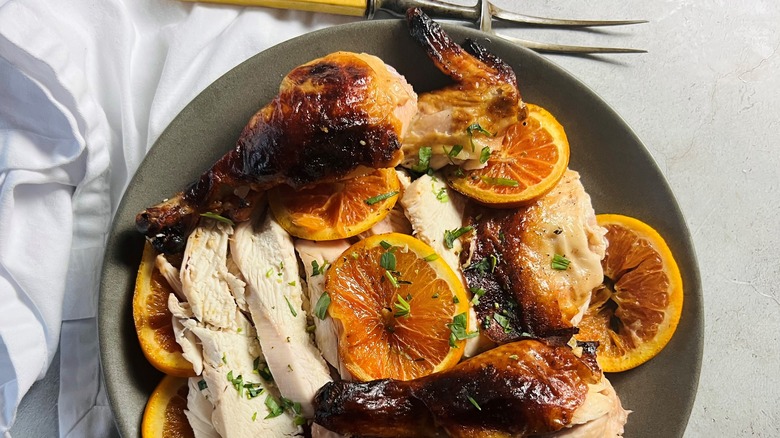 roast chicken with orange on gray plate