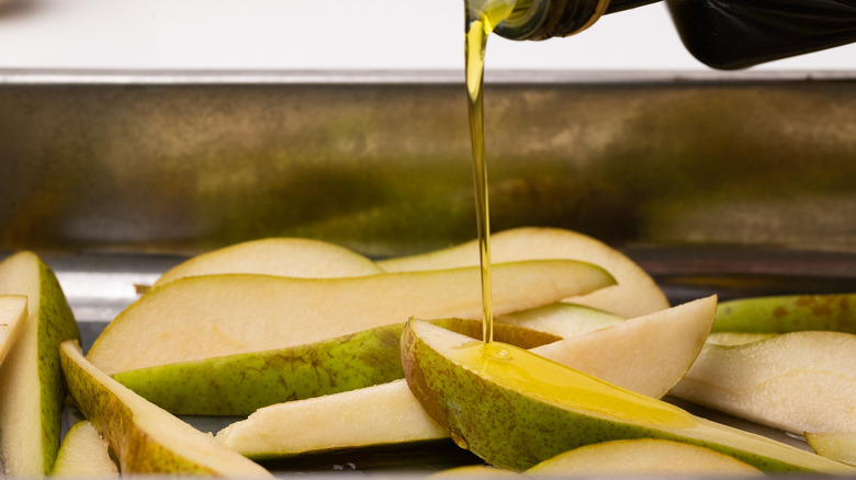 Drizzling olive oil on pears 