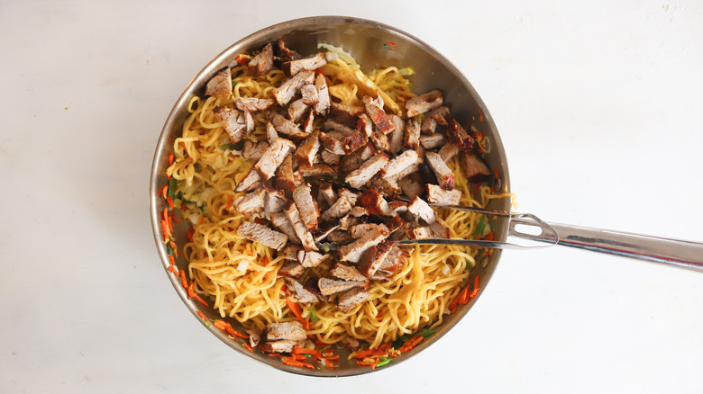 pork noodle vegetable stir fry in pan