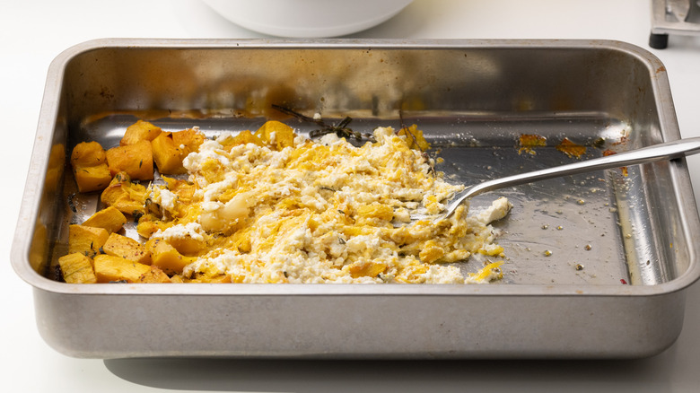 mashing garlic, feta, and pumpkin