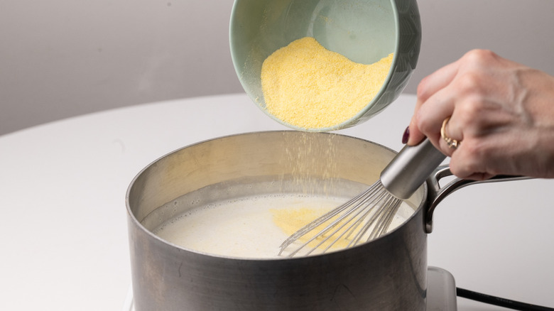 adding polenta to milk