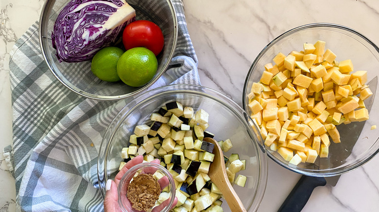 seasoning the cubed rutabaga and eggplant