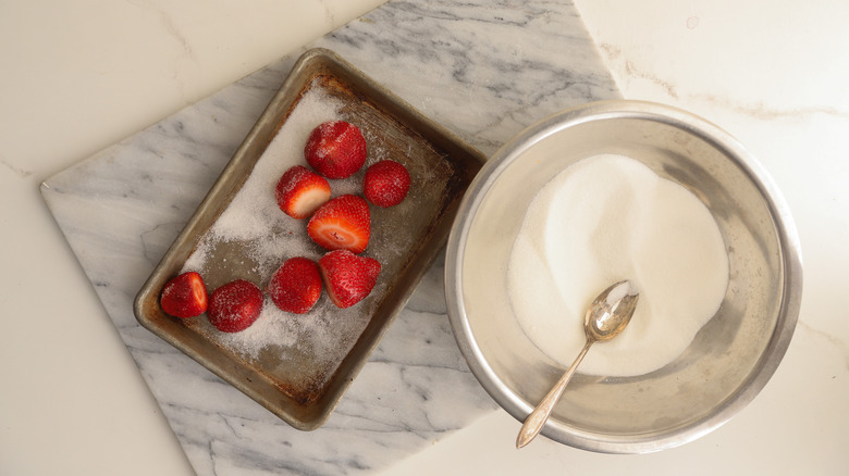 Tossing strawberries with sugar