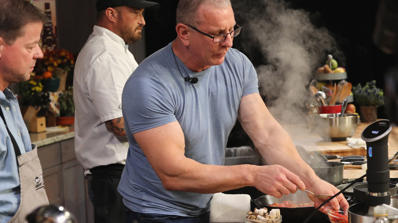 Robert Irvine cooking during demonstration