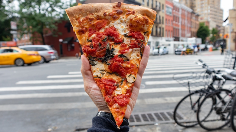 NYC pizza in front of crosswalk 