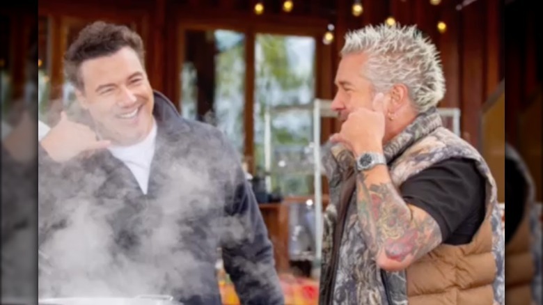 Rocco Dispirito and Guy Fieri miming talking on telephone