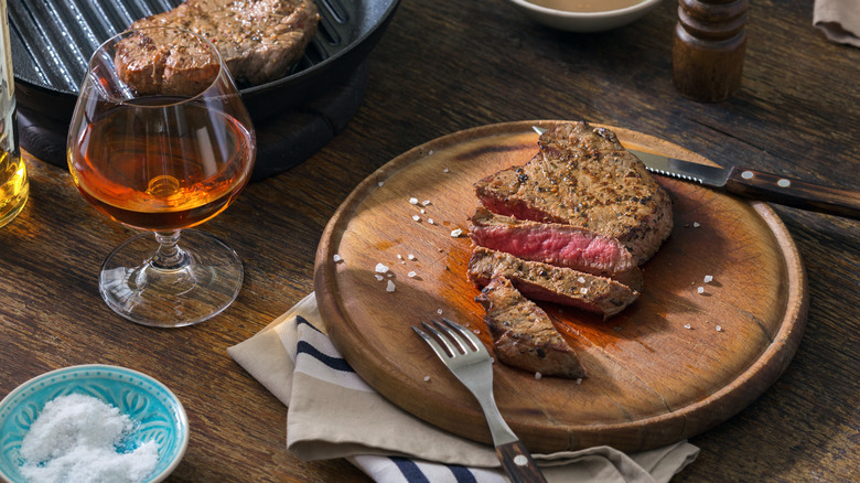 sliced steak with spirit glass