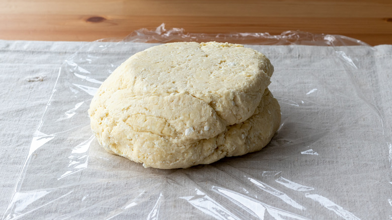 pie dough on plastic wrap