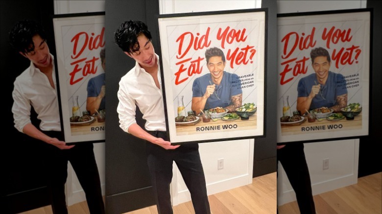 Ronnie Woo with poster of his book