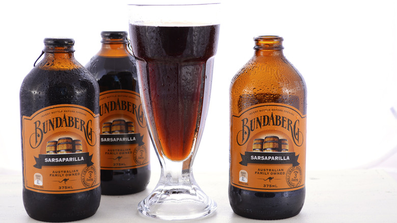 Bundaberg brand sarsaparilla in bottles and a glass