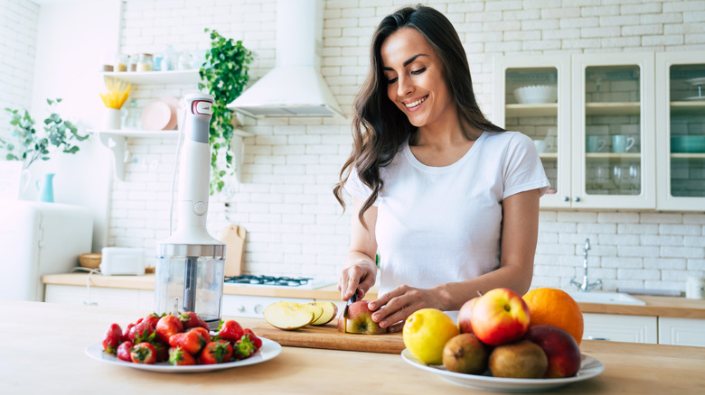 woman chopping fruit