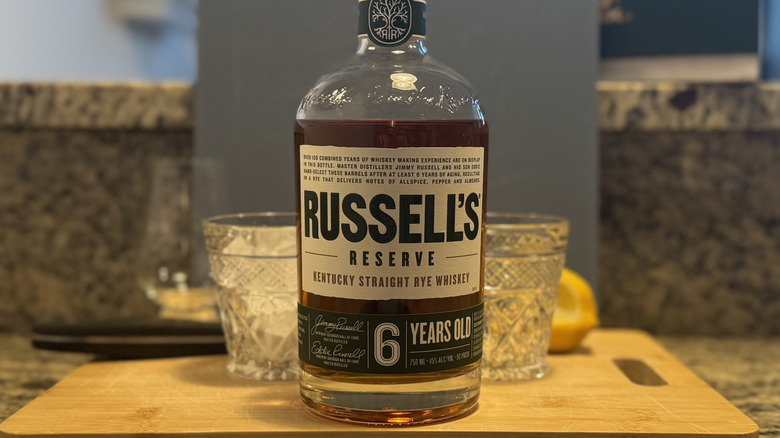 Russell's Reserve bottle on cutting board with glasses