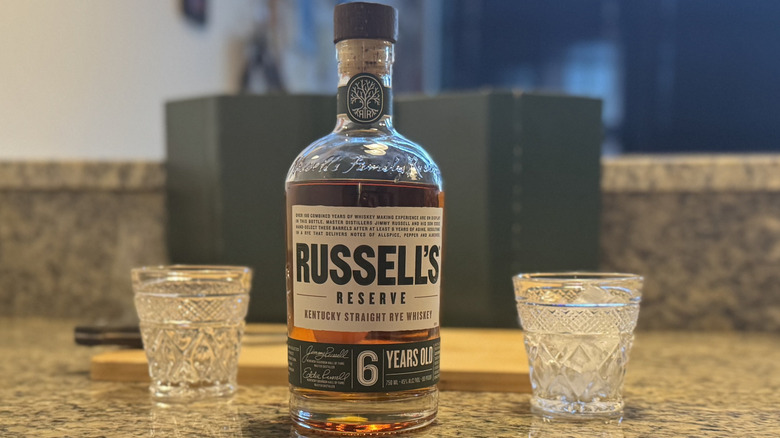 Russell's Reserve bottle with cutting board and glasses