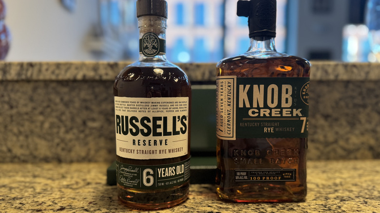 Knob Creek rye bottle beside Russell's Reserve bottle