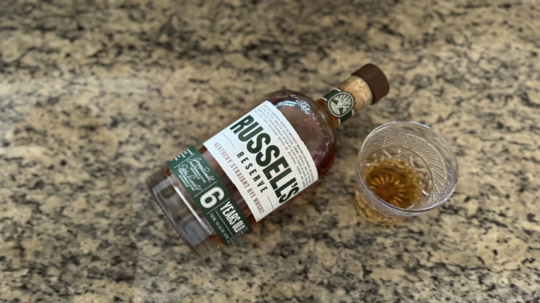 Russell's Reserve rye bottle on counter by neat pour