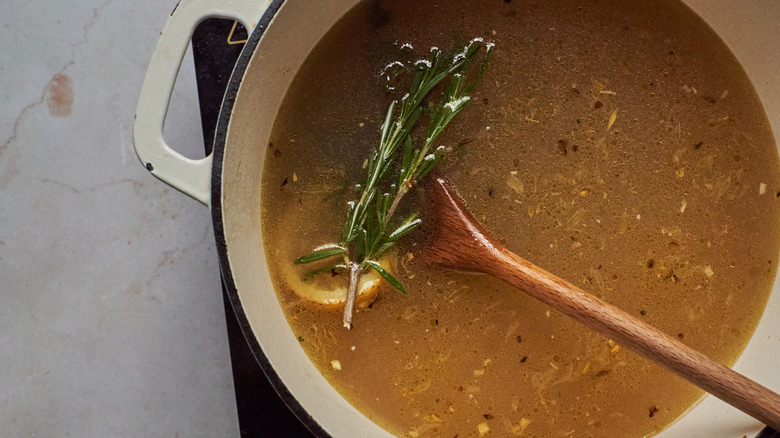 broth with rosemary sprigs