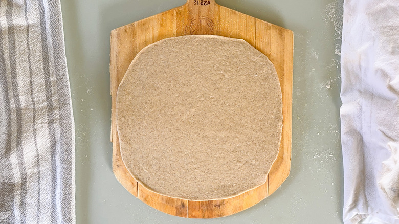 Flatbread dough on pizza peel