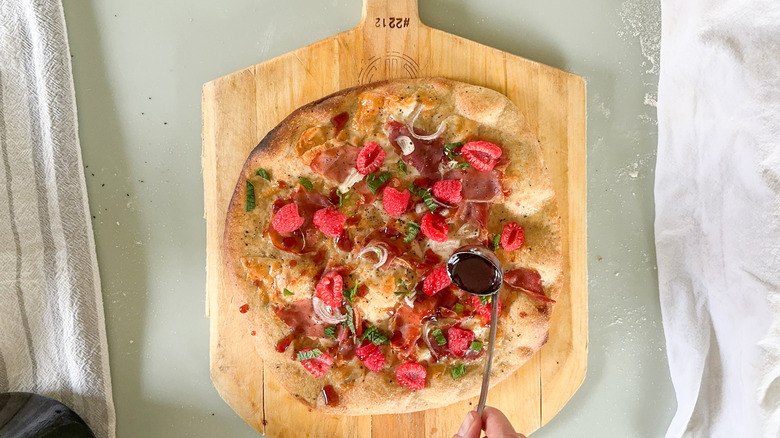 Drizzling rye flatbread with raspberry glaze