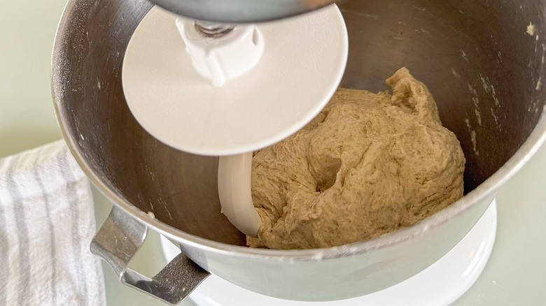 Dough hook on stand mixer kneading flatbread dough