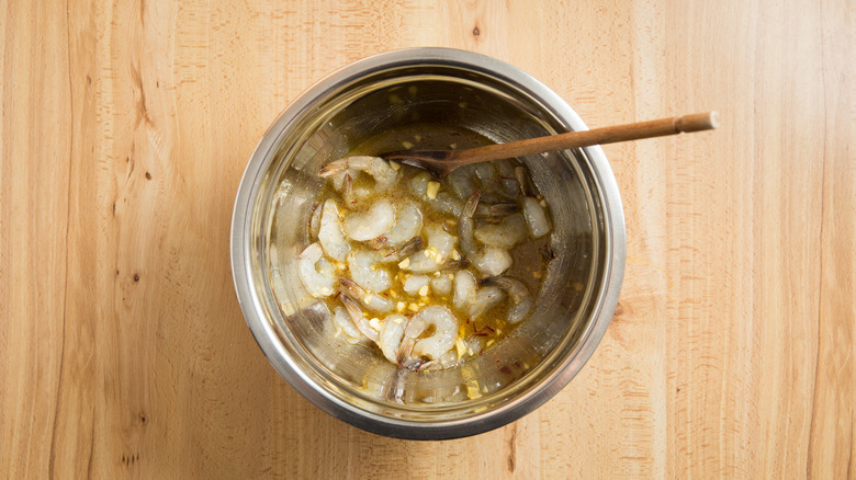 shrimp marinating in mixing bowl 